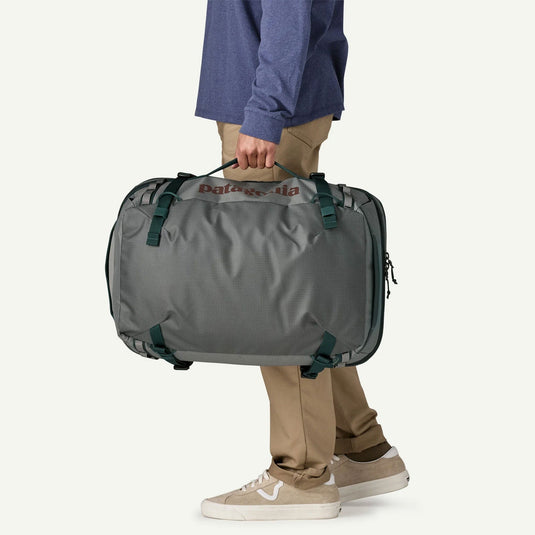 Person holding a gray duffel bag with 'Columbia' branding on a white background