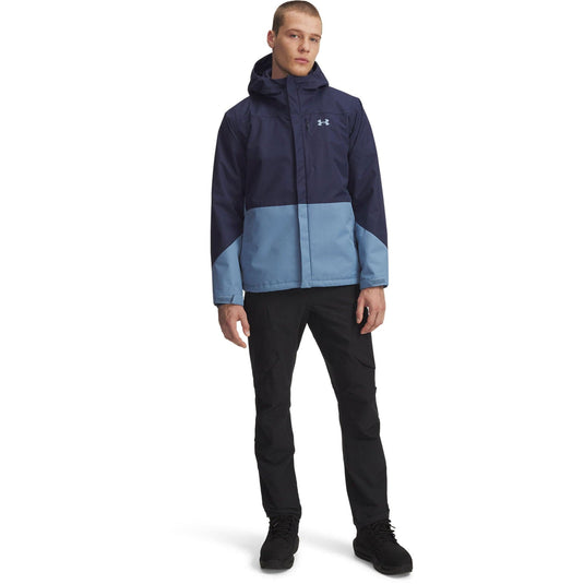 Person wearing a two-tone jacket with Under Armour logo on a white background