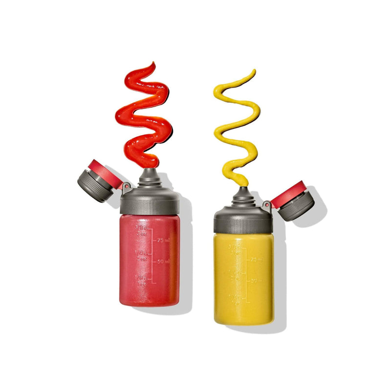 Load image into Gallery viewer, Two bottles of ketchup and mustard with red and yellow sauces spilling out on a white background
