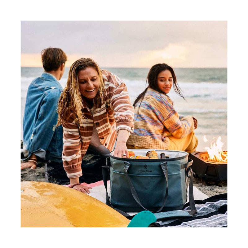 Load image into Gallery viewer, Family by a campfire on a beach with a cooler bag.
