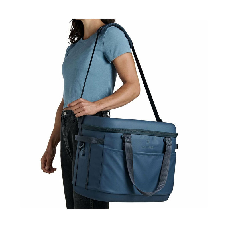 Load image into Gallery viewer, Person carrying a blue bag on a white background
