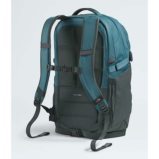 Green and gray backpack with visible brand logo on a light gray background