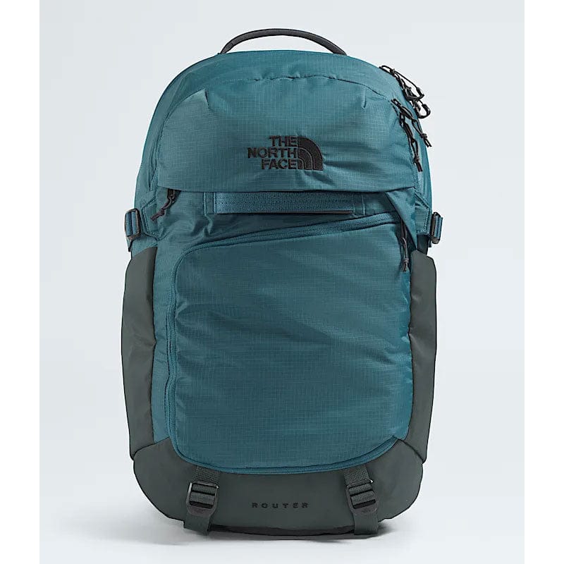 Load image into Gallery viewer, Teal and gray backpack with The North Face logo on a light blue background
