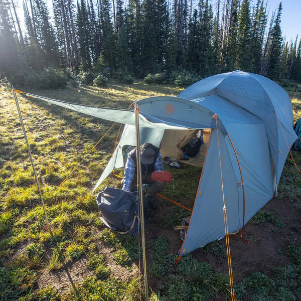 Load image into Gallery viewer, Camping scene with a tent set up in a forested area
