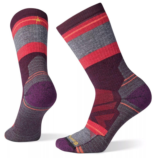A pair of Smartwool women's hike crew socks with a geometric pattern in shades of purple, red, and gray.