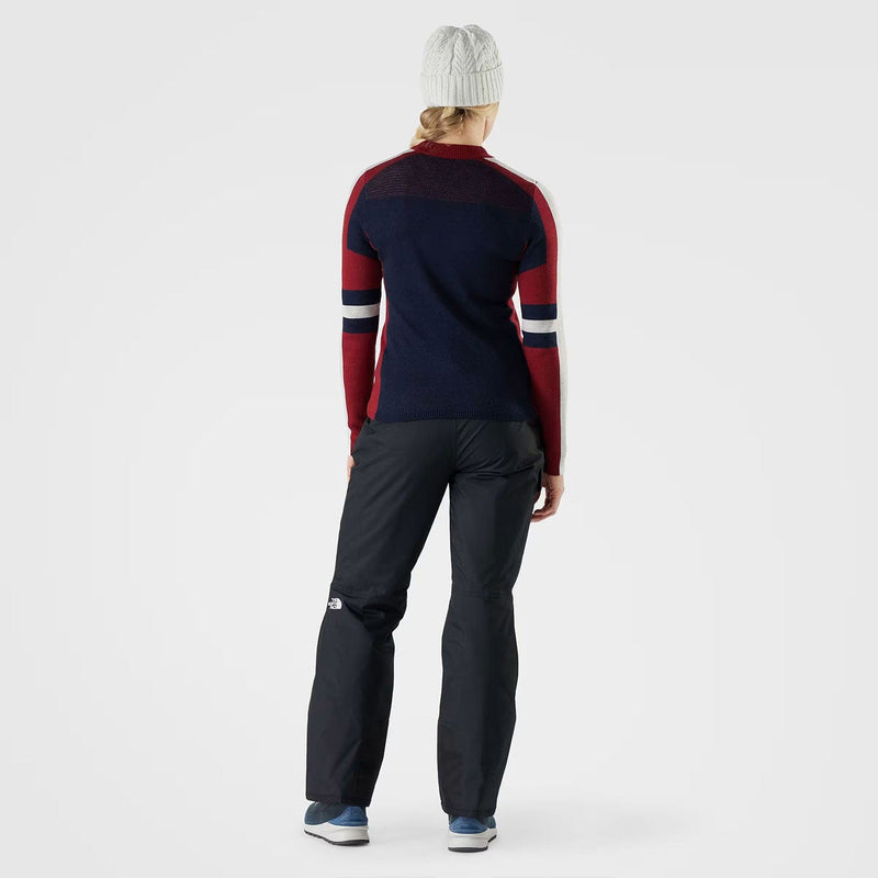 Load image into Gallery viewer, Person wearing a navy and red sweater with dark pants on a white background
