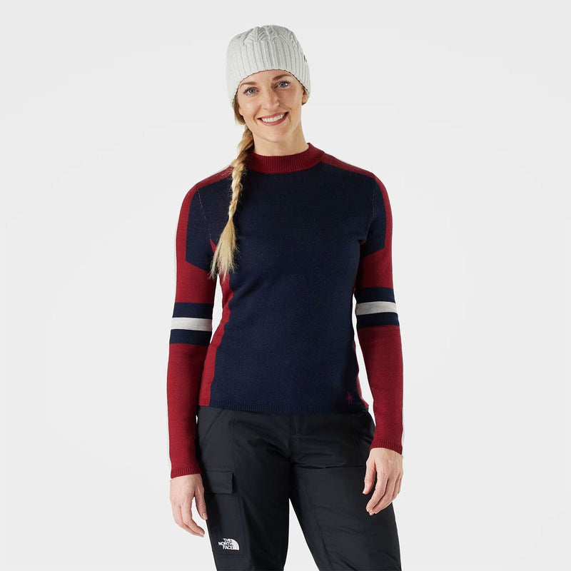 Load image into Gallery viewer, Person wearing a navy and red sweater with black pants on a white background

