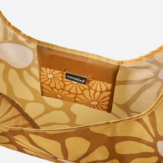 Floral-patterned bag with a visible brand label on a white background
