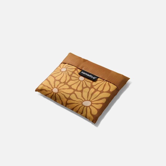 Floral-patterned pouch with a brand label on a white background