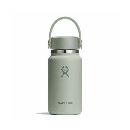 Green Hydro Flask water bottle with a carrying lid on a white background