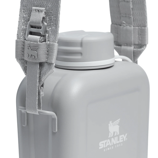 Gray water bottle with a strap and Stanley logo on a white background