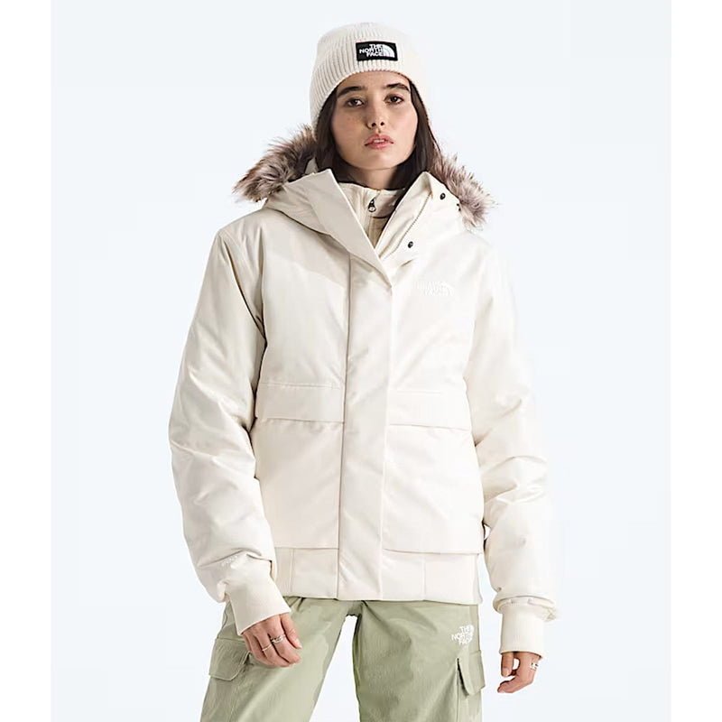 Load image into Gallery viewer, Person wearing a white winter jacket with fur hood and matching hat on a white background
