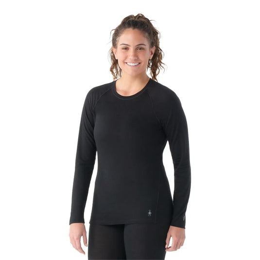 Woman wearing a black long-sleeve athletic shirt on a white background