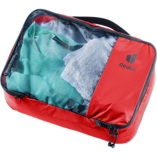 Red packing cube with clothes inside on a white background
