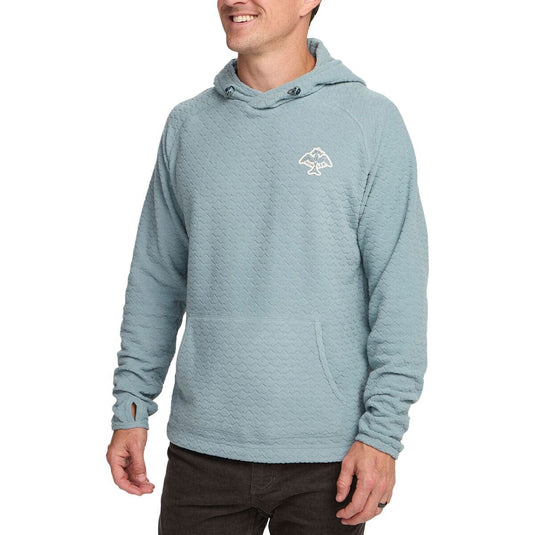 Man wearing a light blue hoodie with a logo on a white background