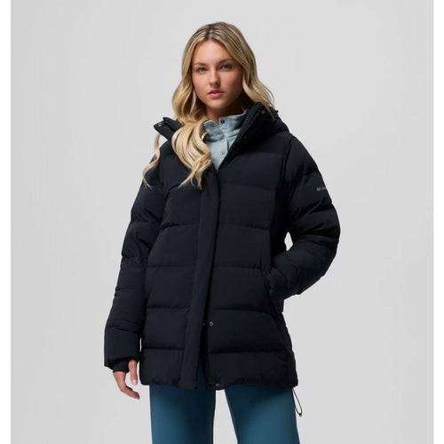 Woman wearing a black puffer jacket on a light gray background