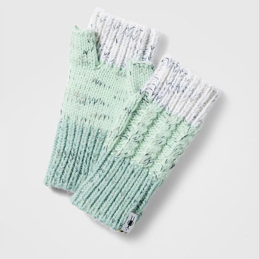 Pair of green and white fingerless gloves on a light gray background