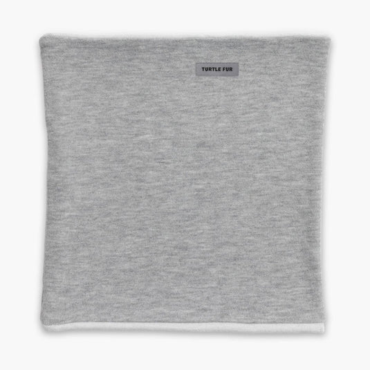 Gray neck gaiter with a brand label on a white background