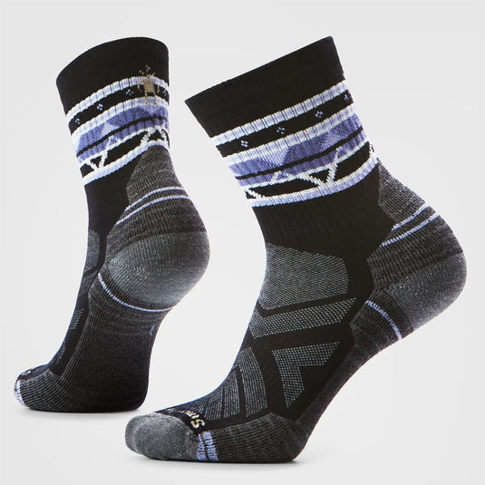 Pair of black and gray patterned socks on a light gray background