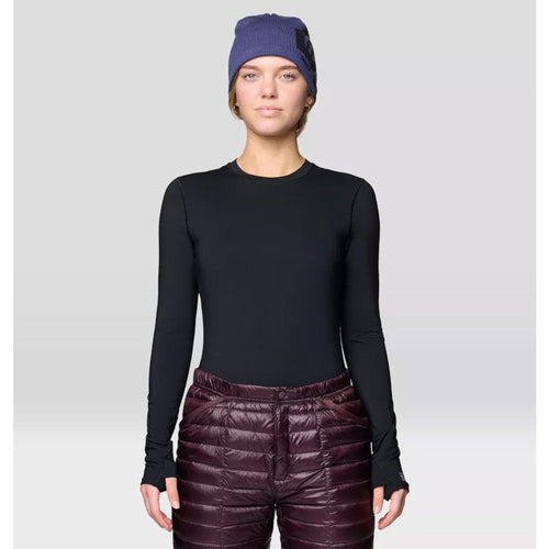 Person wearing a black long-sleeve top and maroon puffer pants with a purple beanie on a light gray background