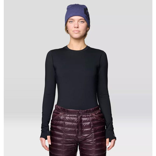 Person wearing a black long-sleeve top and maroon puffer pants with a purple beanie on a light gray background