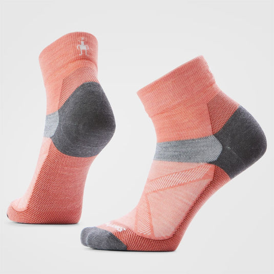 Pair of pink socks with gray accents on a light gray background