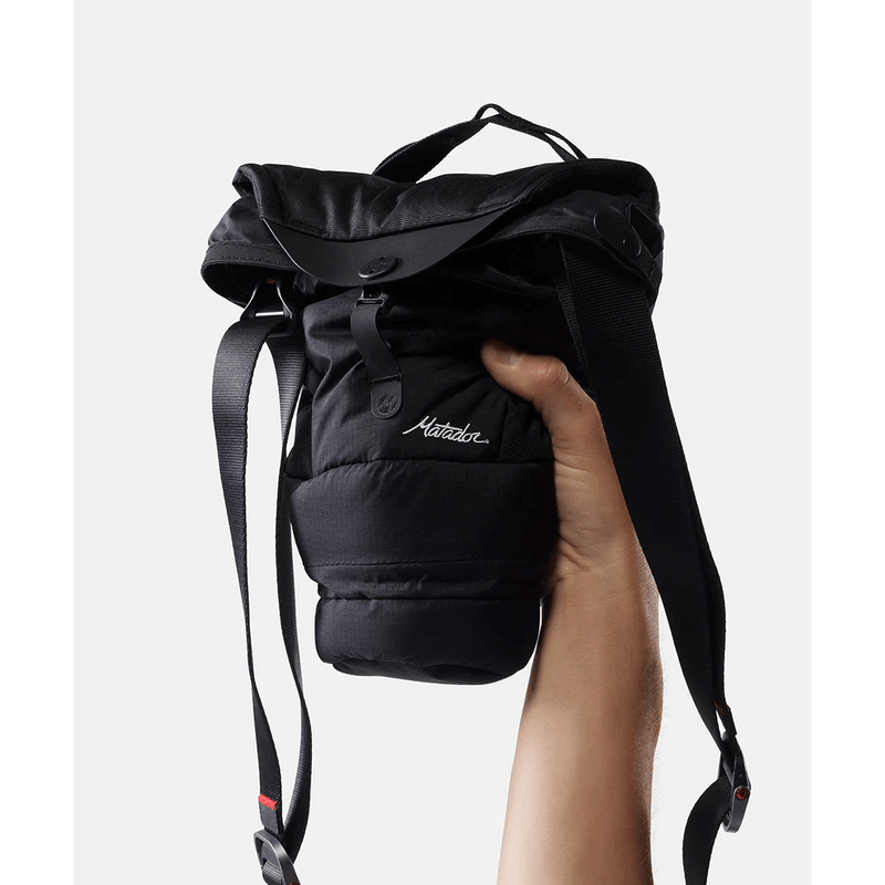 Load image into Gallery viewer, Black backpack held by a hand on a white background
