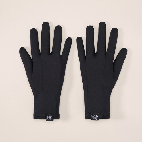Pair of black gloves on a beige background