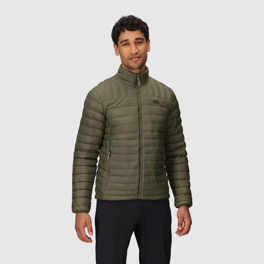 Man wearing a green puffer jacket on a light gray background