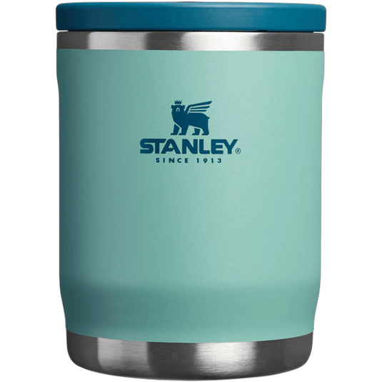 Turquoise Stanley tumbler with a blue lid on a white background