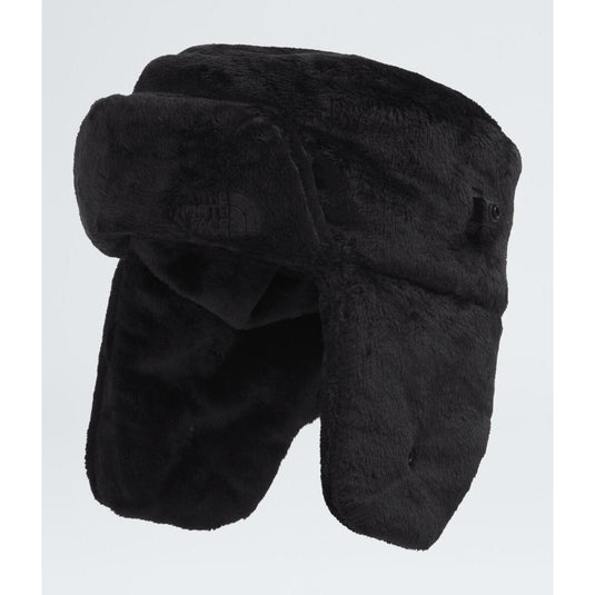 Black winter hat with ear flaps on a light gray background