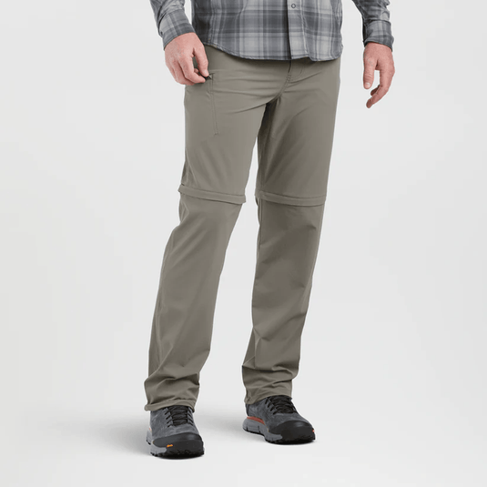 Person wearing beige pants with a plaid shirt on a white background