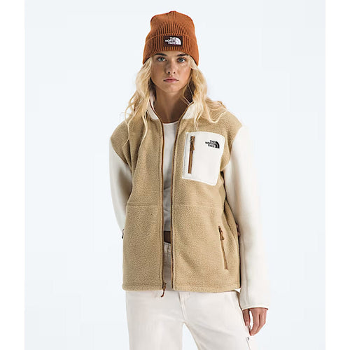 Person wearing a beige vest and brown beanie with The North Face logo on a white background