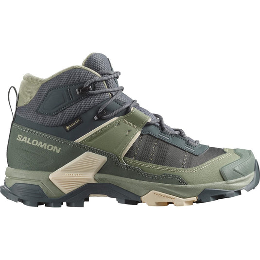 Green hiking boot with Salomon branding on a white background