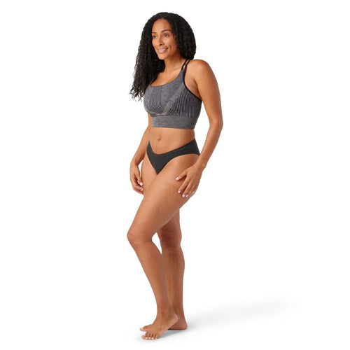 Woman wearing a gray bikini set on a white background