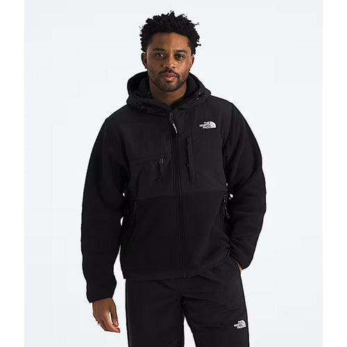 Person wearing a black jacket with a brand logo on a white background