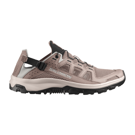 Black sneaker with brand logo on a light gray background