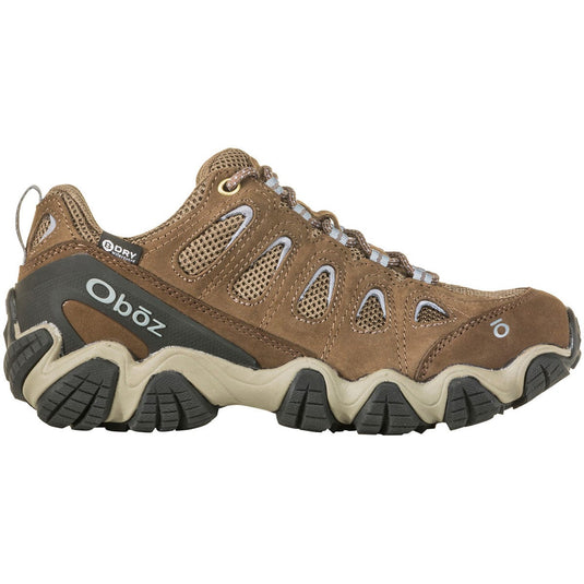 Brown hiking shoe with black sole on a white background