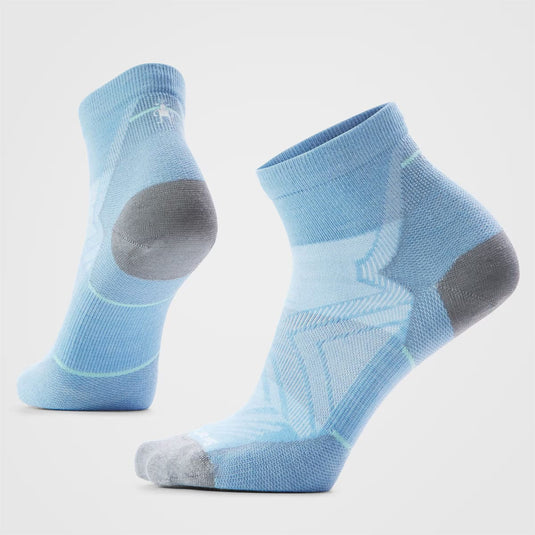 Pair of light blue socks with gray toes and heels on a light gray background