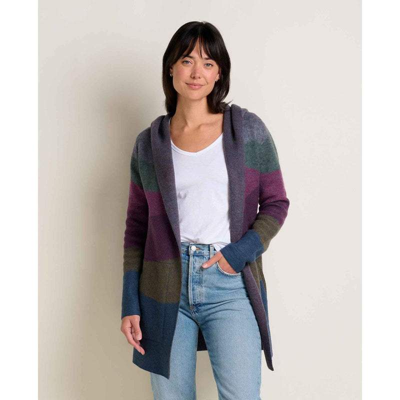 Load image into Gallery viewer, Woman wearing a colorful cardigan over a white shirt and blue jeans on a plain background
