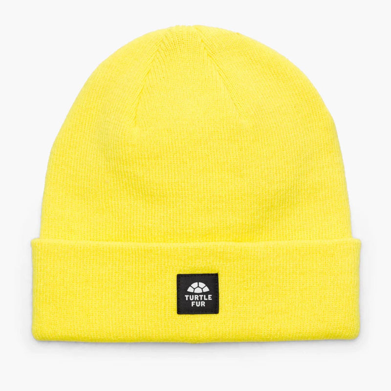 Load image into Gallery viewer, Yellow beanie with a black label on a light gray background
