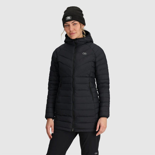 Person wearing a black puffer jacket with a visible brand logo on a light gray background