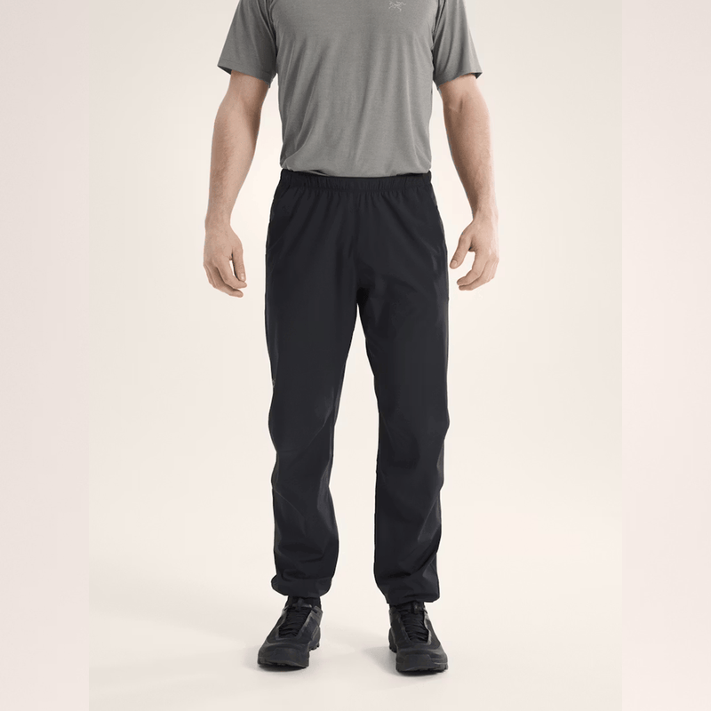 Load image into Gallery viewer, Person wearing black pants and a gray shirt on a beige background
