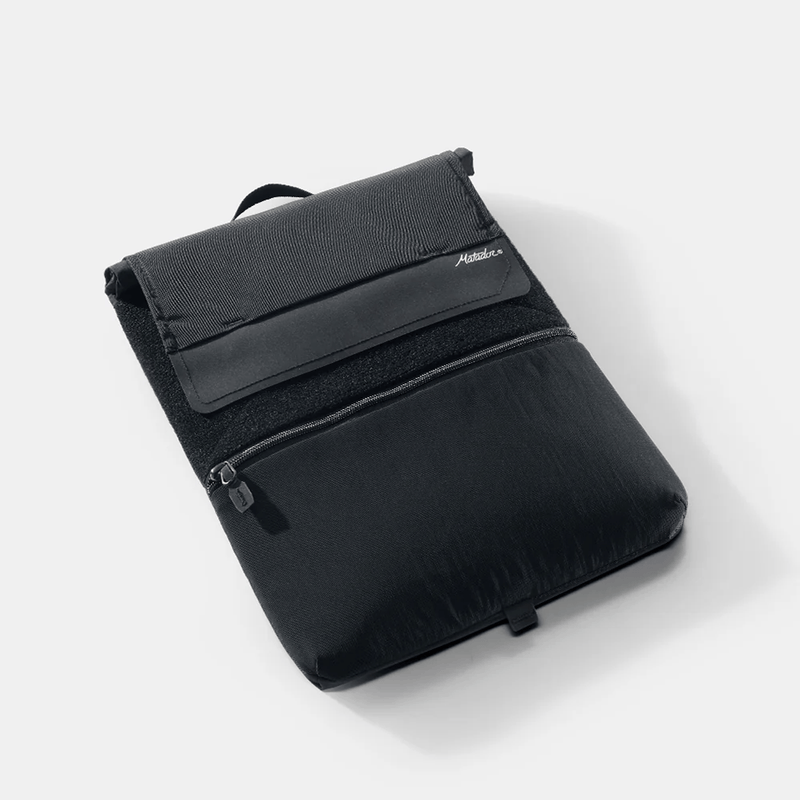 Load image into Gallery viewer, Black backpack with a visible brand logo on a white background
