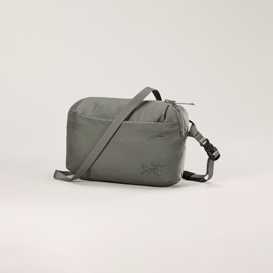 Gray shoulder bag with a brand logo on a light gray background