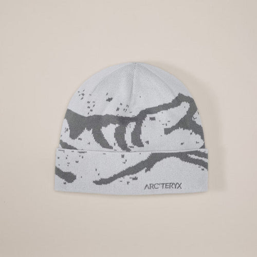 Gray beanie with black pattern and Arc'teryx logo on a beige background