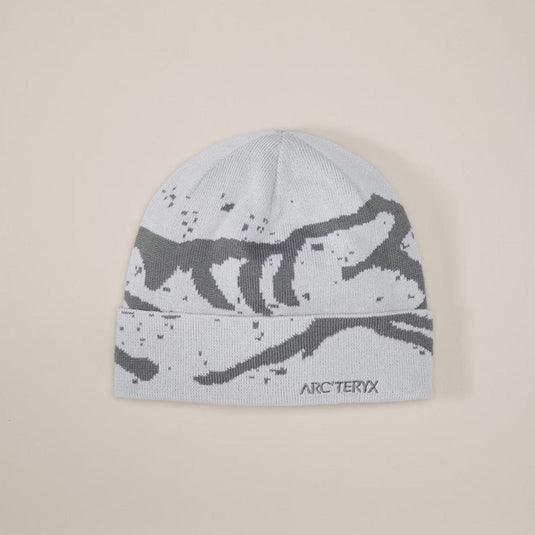 Gray beanie with black pattern and Arc'teryx logo on a beige background