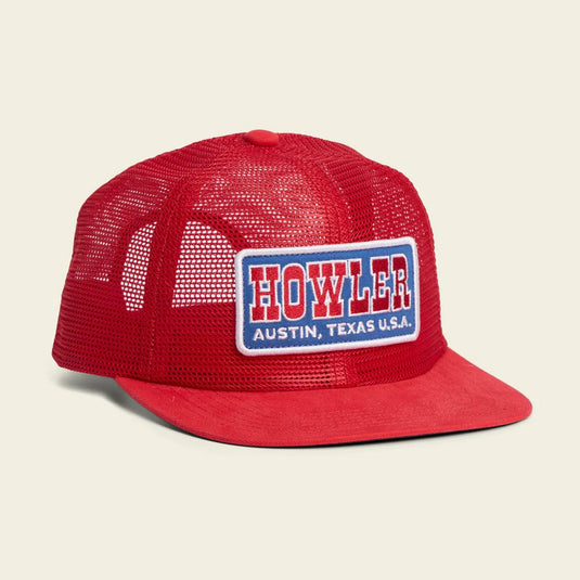 Red mesh cap with 'HOWLER' logo on a beige background