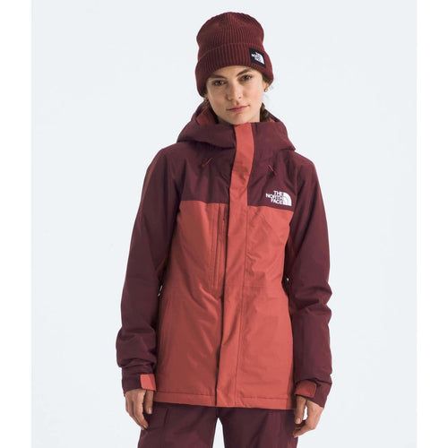Person wearing a maroon jacket and beanie with The North Face logo on a white background
