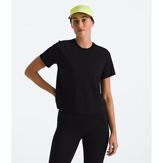 Person wearing a black outfit with a yellow cap on a white background